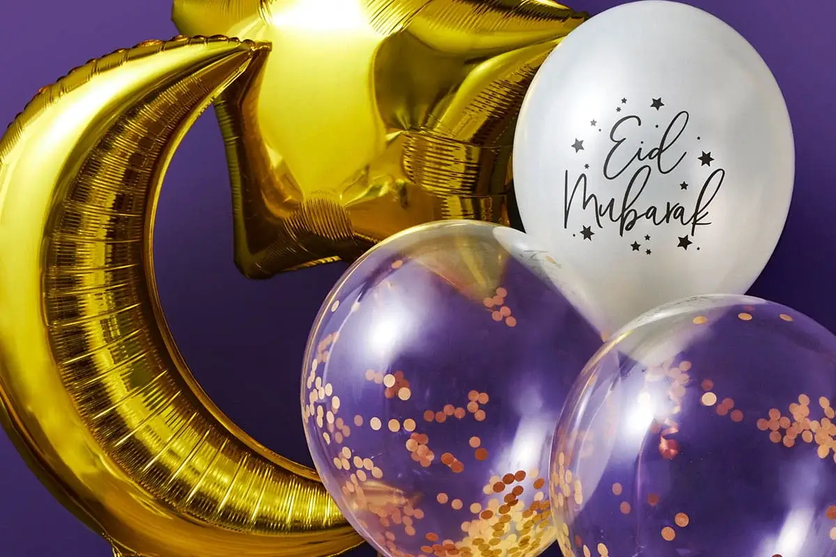 Gold crescent moon and star balloons paired with white and clear confetti balloons featuring an Eid Mubarak design against a purple background.